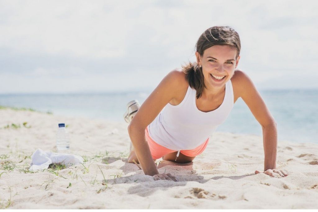 Ensure you guard against b12 deficiency and you'll have vibrant energy like this young woman doing pushups on the beach