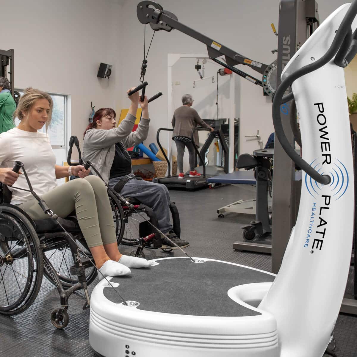 Woman using the power plate pro7hc in a wheelchair